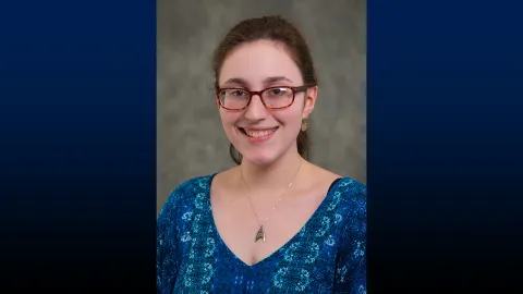 Headshot of smiling woman in blue shirt