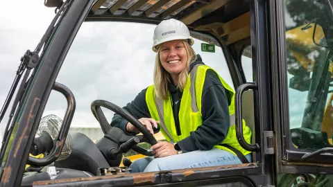 UW-Platteville senior Kira Goldbach smiles from the cab of a telehandler vehicle at the university's construction lab on Sept. 22, 2026.