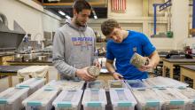 Dylan Notsch and Will Straka (left to right) study the effects of anti-icing on concrete.