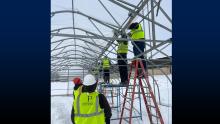 Students erecting a greenhouse.