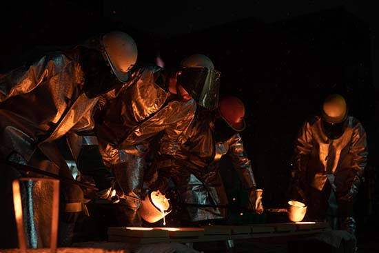 UW-Platteville students work in foundry pouring metal