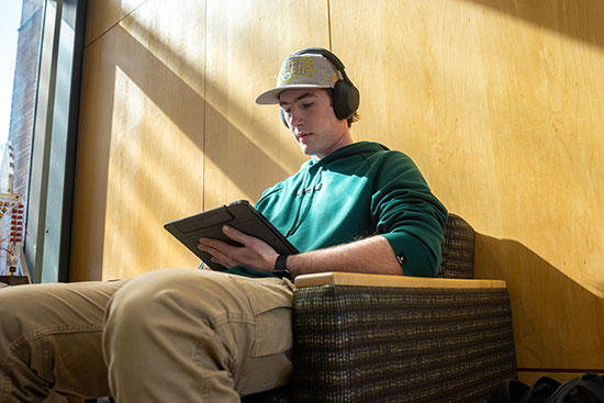 UW-Platteville student sits in academic building reading