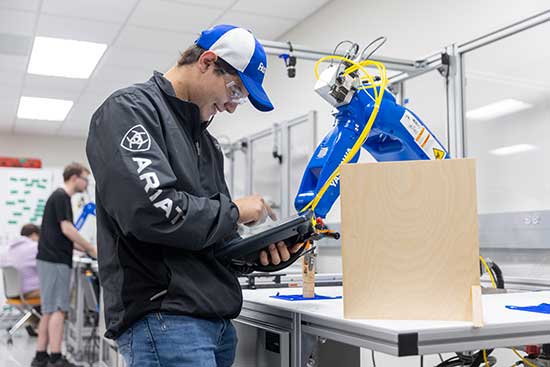 Engineering Technology Management student working with machinery