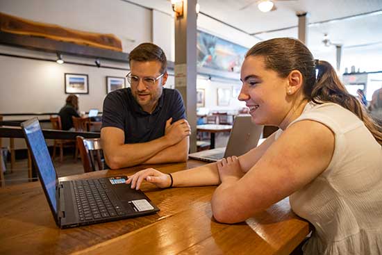 UW-Platteville psychology student and faculty member review research data on a laptop.