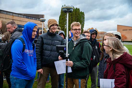 A group of environmental engineering students gathered on UW-Platteville campus grounds for a lab.
