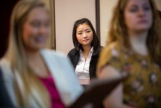 Woman in suit looking towards camera