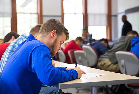 UW-Platteville students focus on writing while sitting in an Ethnic Studies class