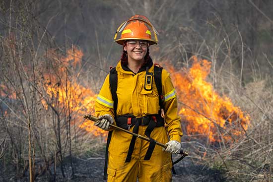 UW-Platteville student smiles while assisting with controlled burn