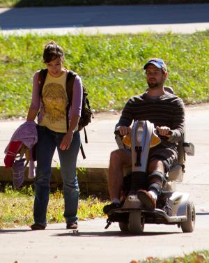 Student riding mobility scooter