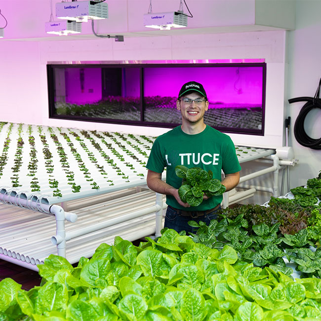 Zack Peterson working in hydroponics lab