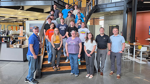Group of students and faculty standing on a staircase