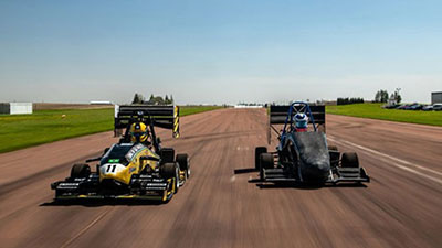 Two Formula SAE cars race in a practice run