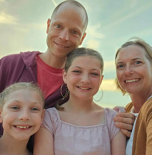 Frayer pictured with his wife, Kelly, and their daughters Nora and Eva.