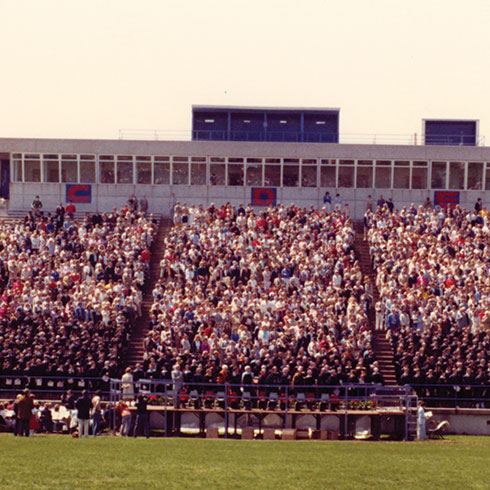 1983 Graduates in stadium stands for ceremon.