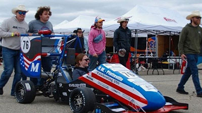 UW-Platteville Pioneer Racing team push Formula SAE car