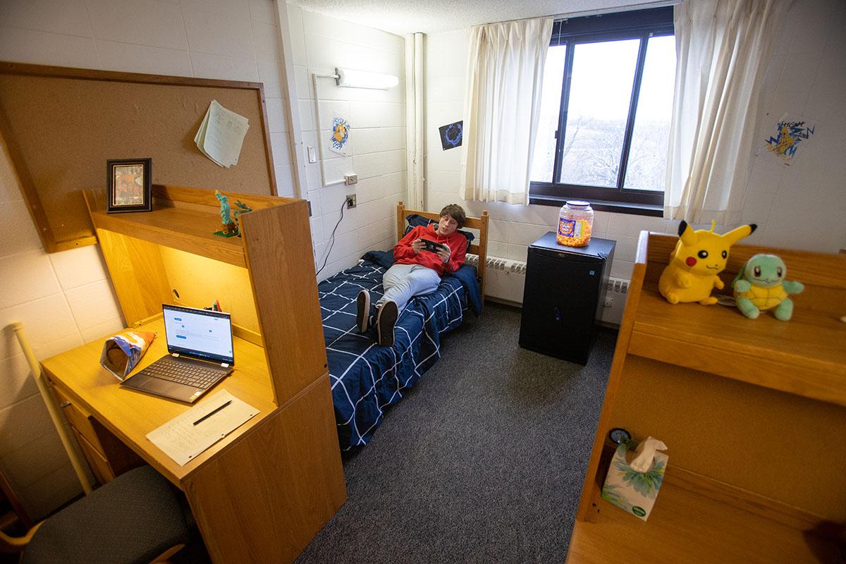 Student laying down in dorm room of Pickard