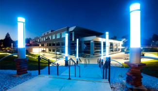 Exterior photograph of UW-Platteville building with bright sidewalk lighting in the foreground