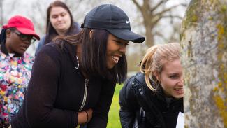 students looking at a headstone