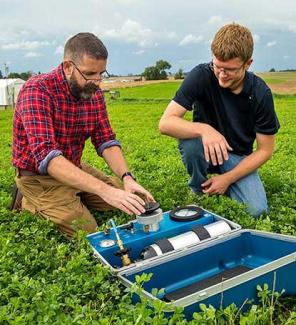 student and professor conducting research in field