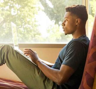 UW-Platteville student studying indoors near a window