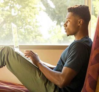 UW-Platteville student studying indoors near a window