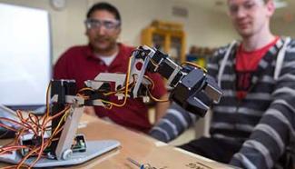 students working with a robot