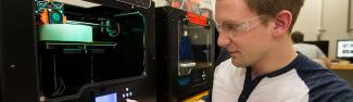 Student working with 3D printers