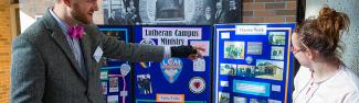 Student showing Lutheran Campus Ministry display