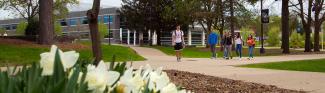 Students walking in spring outside of Ullsvik Hall