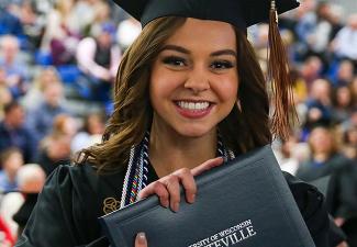 UW-Platteville graduate holding diploma