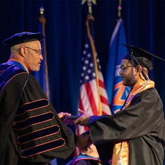 A UW-Platteville graduate receiving his diploma