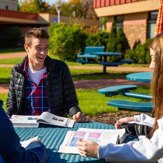 Baraboo students outside at table
