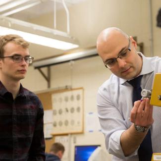 Engineering student with faculty in lab