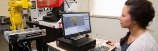 A student working on a 3D model on a computer