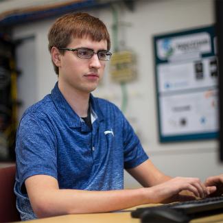 Computer science student working on a computer