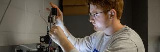 Mechanical Engineering student working on machine
