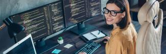 Woman working on multiple display computer setup