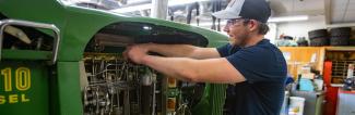 Student working on tractor engine 