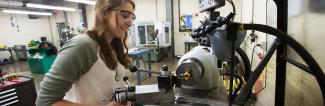 Student working with heavy machinery
