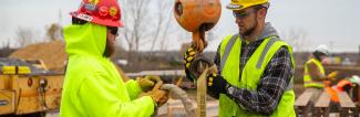Students working with heavy construction equipment