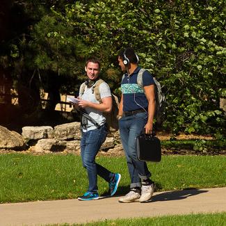 Students walking on campus in fall