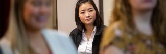 Woman in suit looking towards camera