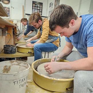 students working with clay