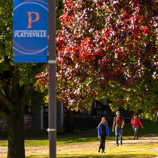 Students walking on campus in the fall