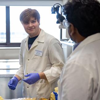 Biology student in anatomy lab with professor