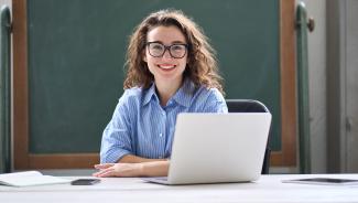 young educator working on laptop