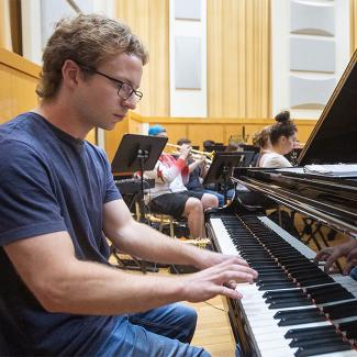 Elliott Loughney, a junior civil engineering and music double major, playing piano