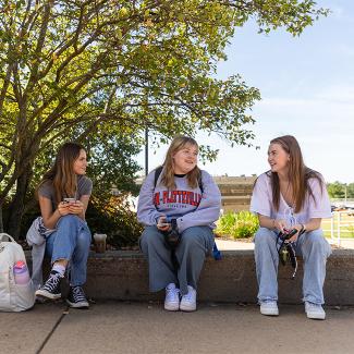 Three UW-Platteville students sitting outside