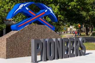 Pioneers with pickaxes sign