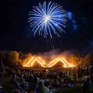 Fireworks above lit M on Homecoming